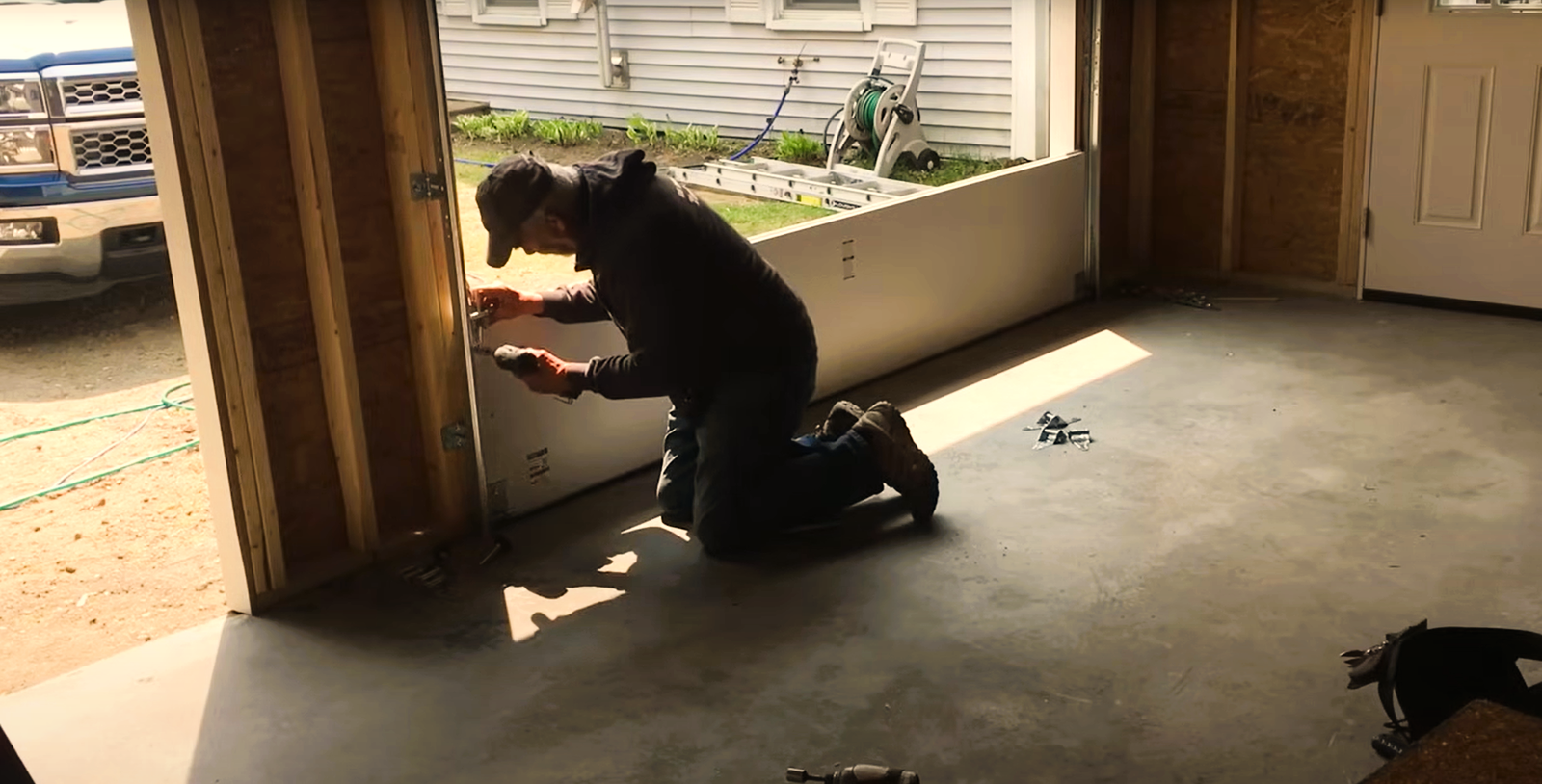Technician performing garage door panel repair on a residential garage in Clintonville, ensuring smooth operation and durability.