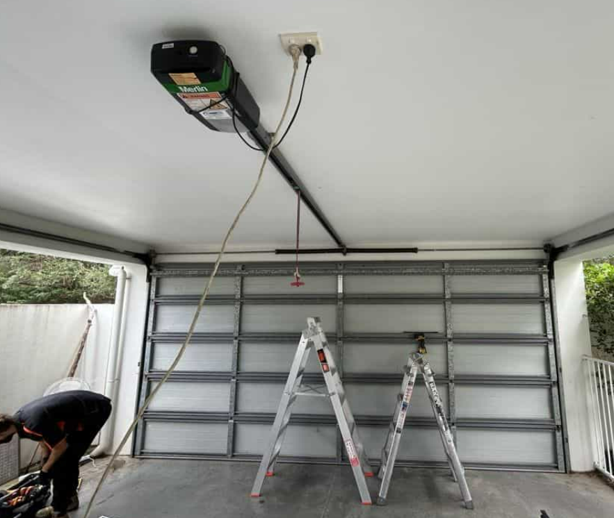 Technician repairing a local garage door in Clintonville, showcasing professional garage door repair services for residential homes.