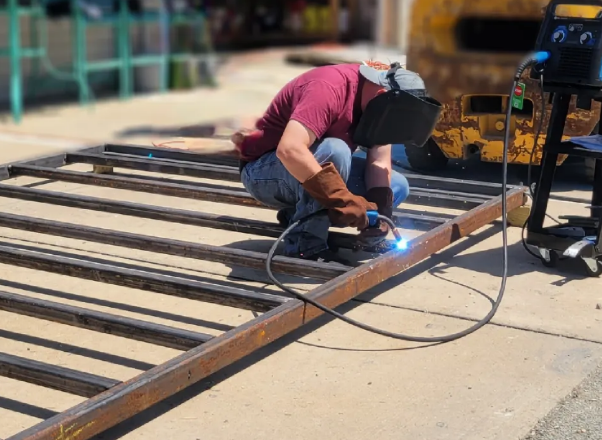Technician performing professional gate repair on a residential metal gate in Clintonville, ensuring smooth operation and enhanced security.