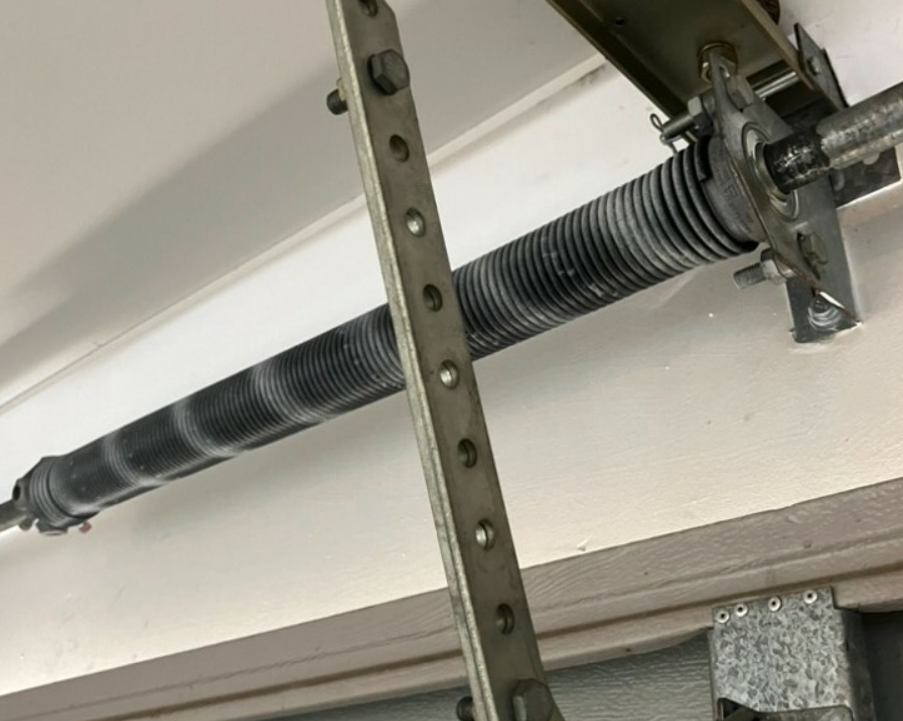 Clintonville garage door spring repair service with a technician adjusting torsion springs for optimal garage door function