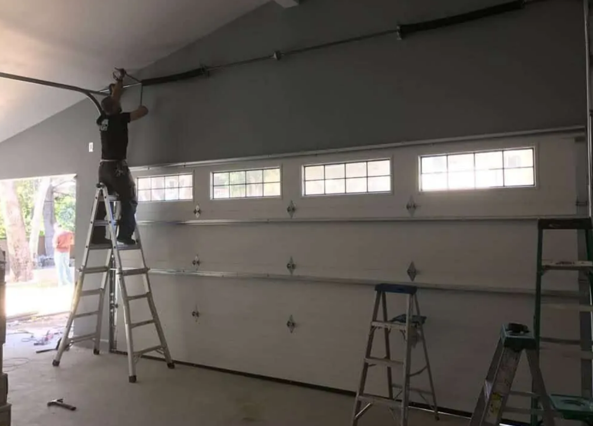 professional technician from Clintonville Garage Door Repair LLC expertly fixing a residential garage door, showcasing their top-tier garage door repair services in Clintonville.