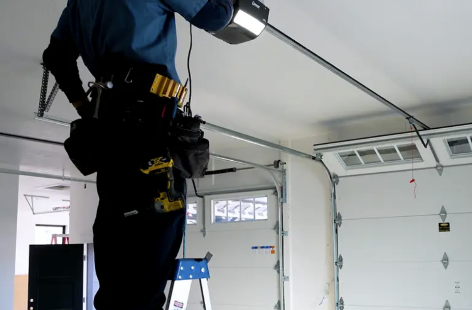 Technician performing a garage door opener repair in Clintonville