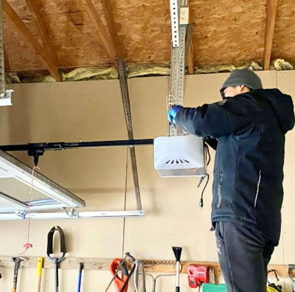 a professional technician performing garage door opener repair in Clintonville, highlighting expert services for smooth and efficient garage door operation.