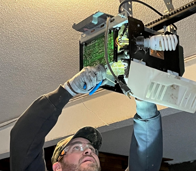 Technician performing garage door opener repair in Clintonville