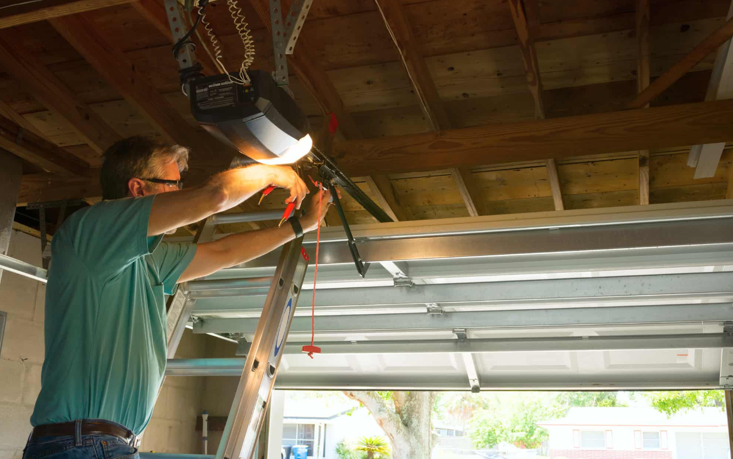 Technician replacing a broken garage door torsion spring in Galloway Ohio